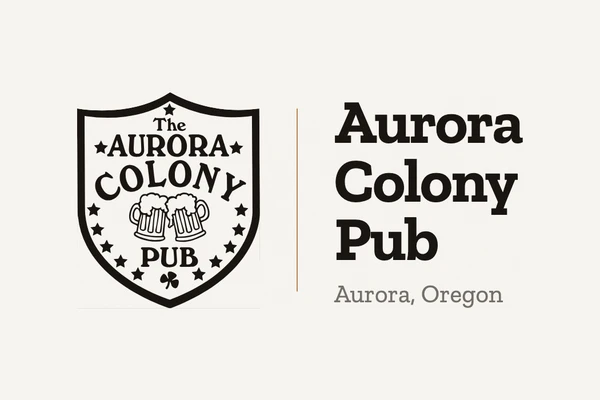 The Aurora Colony Pub shield logo, with two beer mugs, beside the pub name and "Aurora, Oregon".
